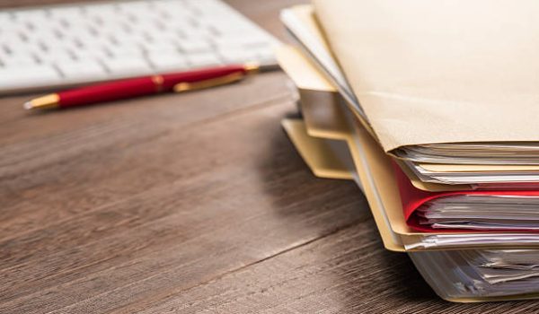 Office supplies. Stacked Files Paperwork on Desk.Shot with Nikon D800E ISO100.